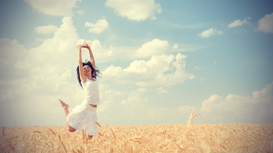Happy-woman-jumping-in-golden-wheat-my-positive-life